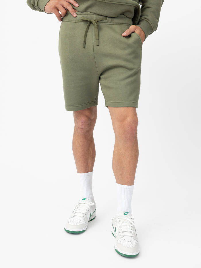 Man wearing Juniper CityScape Shorts with white background |Color: Juniper