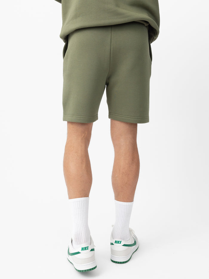 Man wearing Juniper CityScape Shorts with white background |Color: Juniper