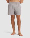 A person stands barefoot wearing the Cozy Earth Men's Day & Night Short 5" in light gray, featuring an elastic waistband. The image is cropped from the waist down against a plain white background. |Color:Stone