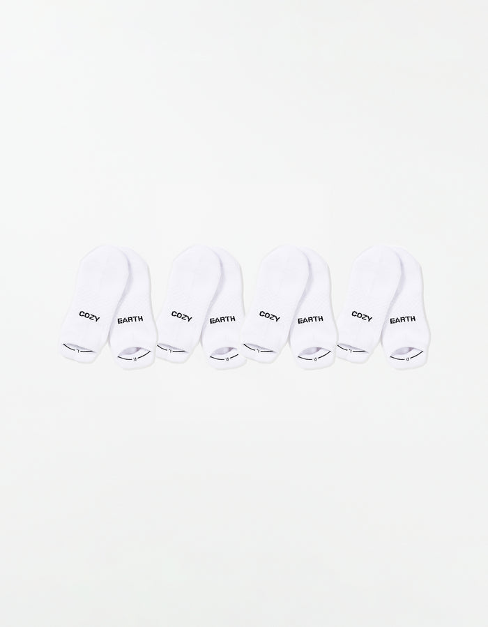 The Essential Ankle Sock 4-Pack by Cozy Earth features four pairs of white ankle socks, each with "COZY" and "EARTH" printed in black on top, arranged in a row on a white background. |Color:White