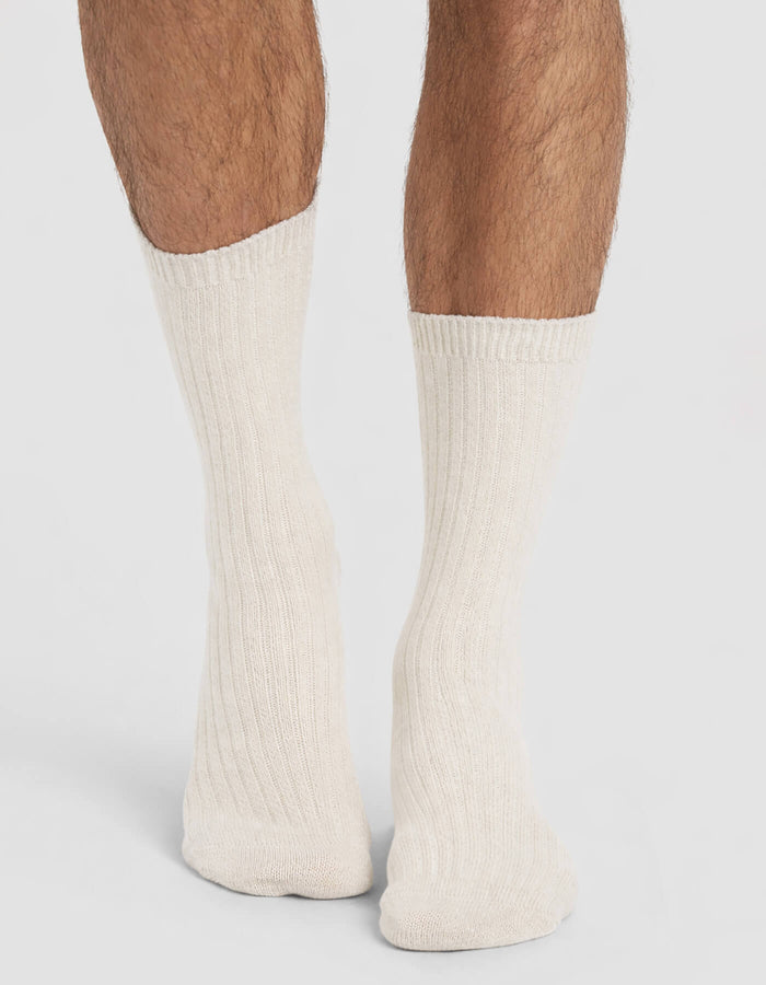 A person wearing Cozy Earth Men's Plush Lounge Calf Socks, standing with their feet close together on a plain background.|Color:Alabaster