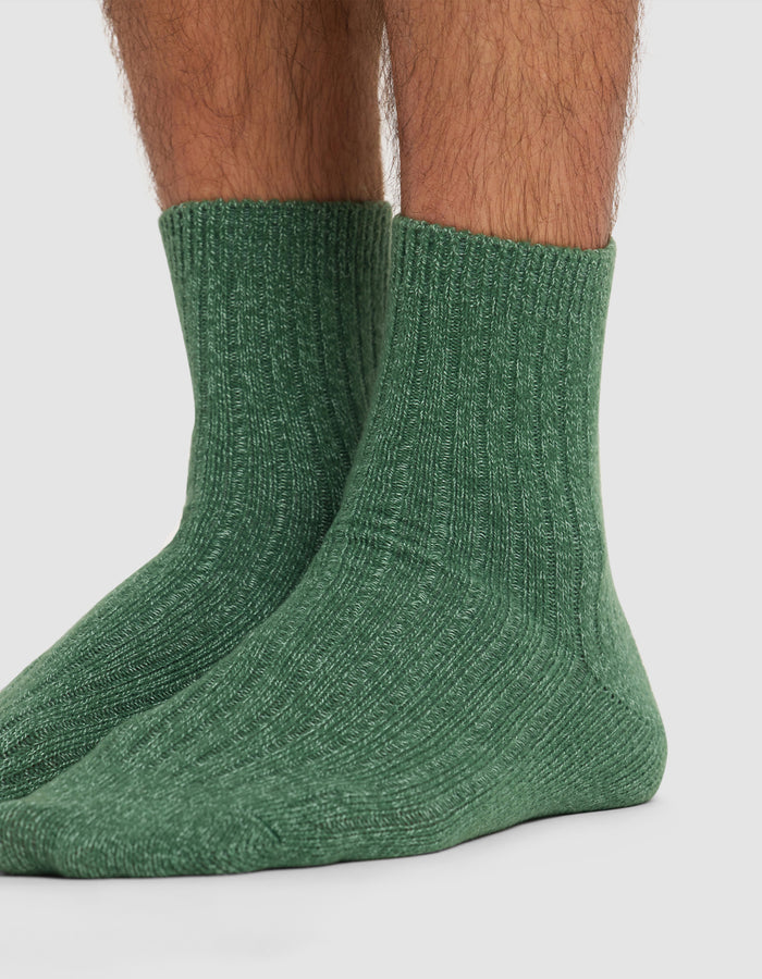 A close-up of lower legs and feet wearing Cozy Earth's Plush Lounge Quarter Sock 3-Pack in green, shown against a plain white background.|Color:Jade/Wintergreen/Pistachio Cream