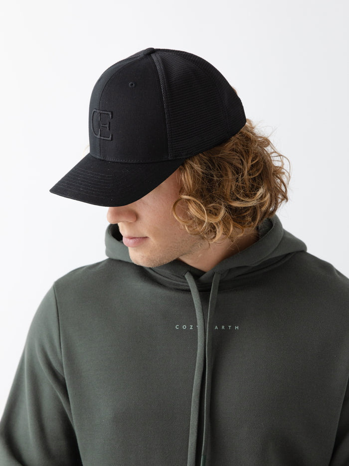 Man wearing a black cap with a CE logo on a light gray background |Color:Black