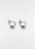 Micro drop silver metal earrings by LEMAIRE flat lay on white background showing front detail