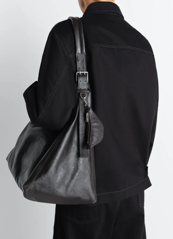 Mini Croissant Keyring in Grained Leather, model shot, back view hanging on bag