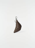 Mini croissant leather keyring in dark brown with silver hardware by LEMAIRE on plain white background