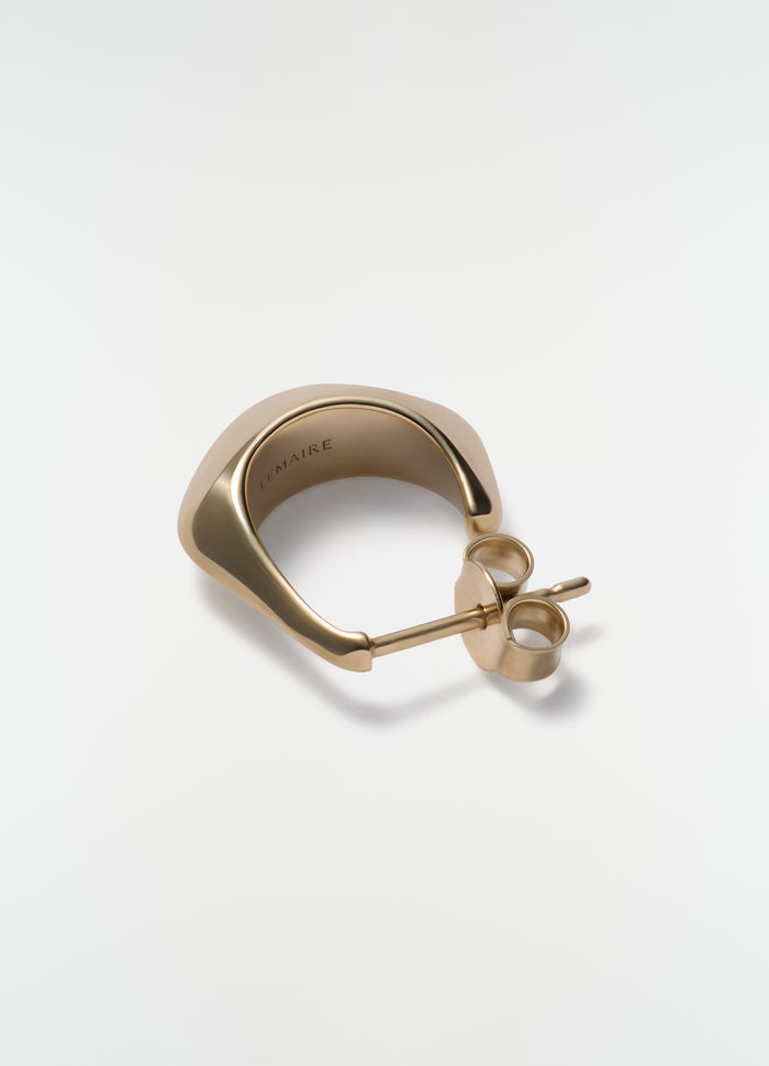 Mini drop earring in gold vermeil metal by LEMAIRE close-up on plain white background showing post and back closure
