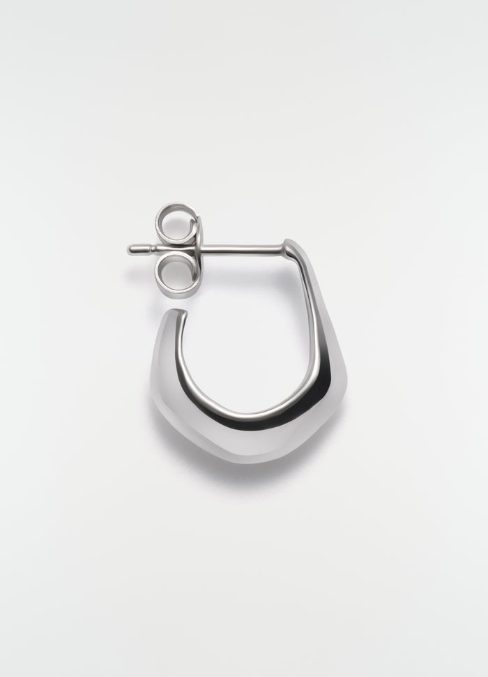 Mini silver metal drop earring by LEMAIRE on plain white background close-up detail
