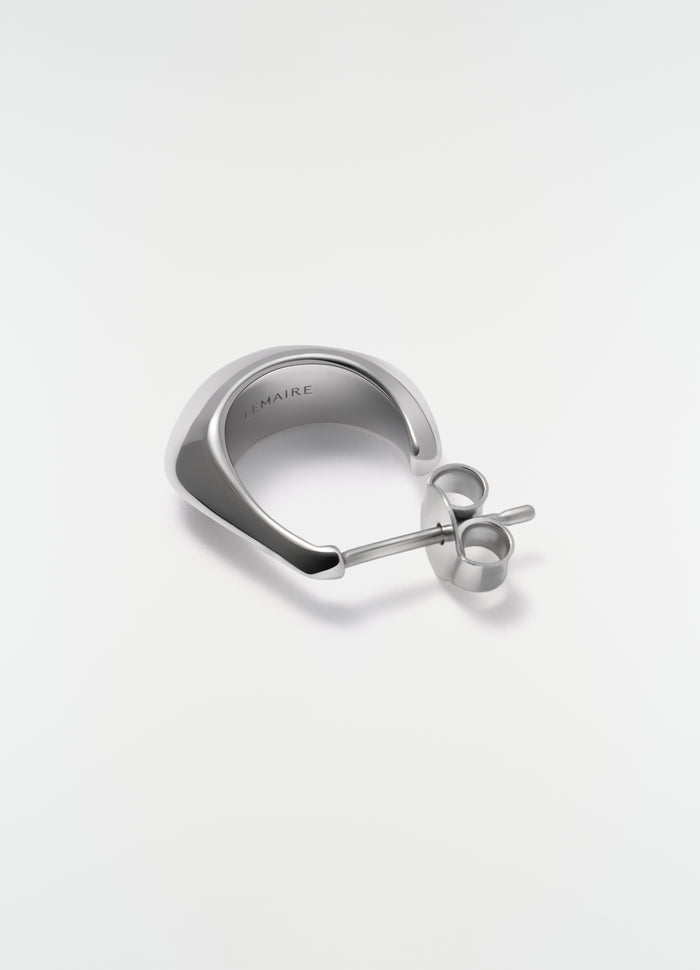 Mini drop silver earring in polished metal by LEMAIRE close-up detail on white background