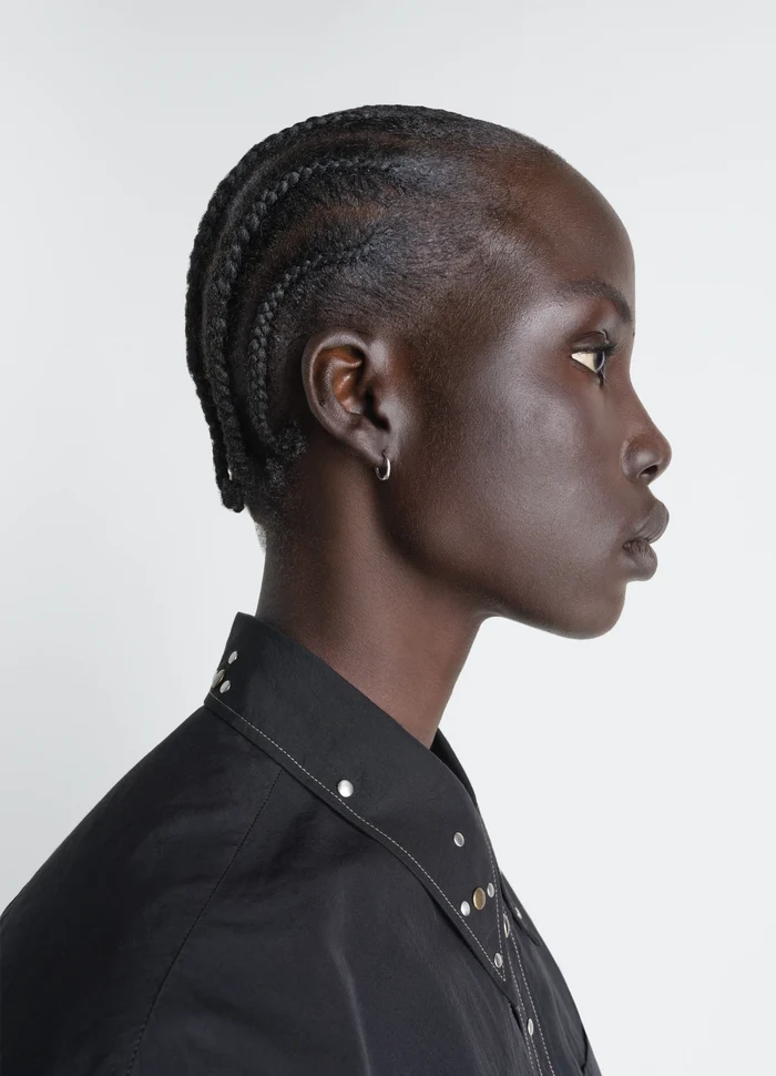 Piercings Set in Silver in Rhodium-Plated Silver, model shot, profile view worn with braided hairstyle