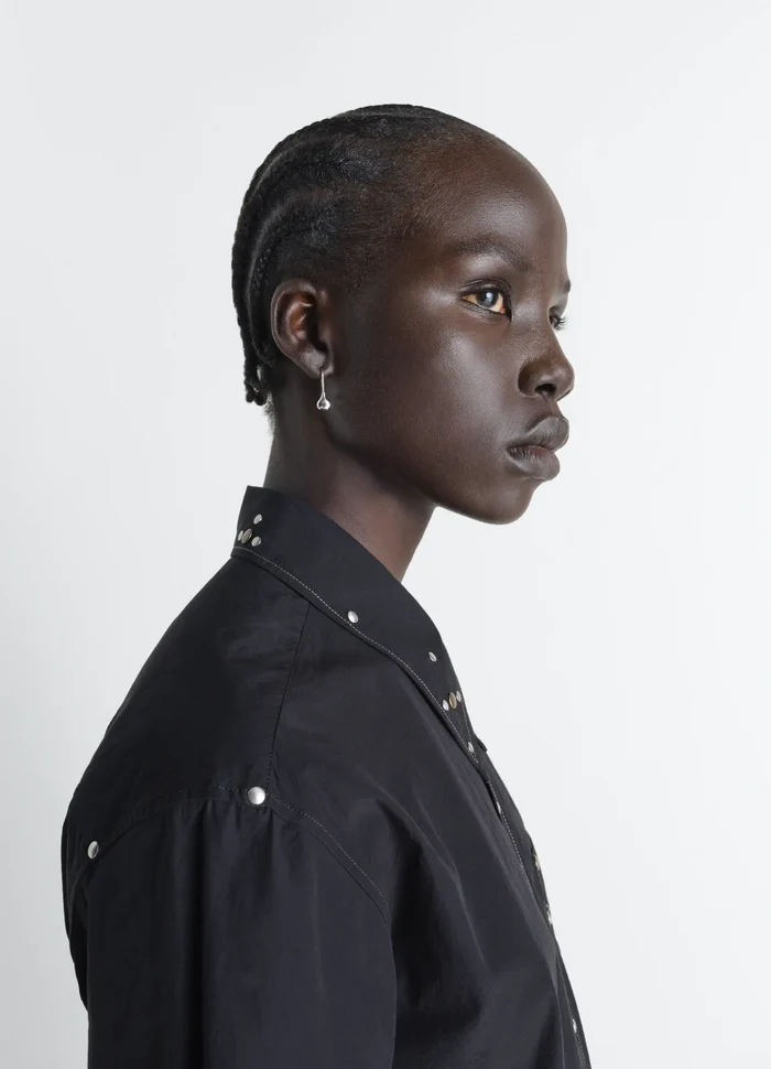 Piercings Set in Silver in Rhodium-Plated Silver, model shot, three-quarter view paired with sleek hairstyle