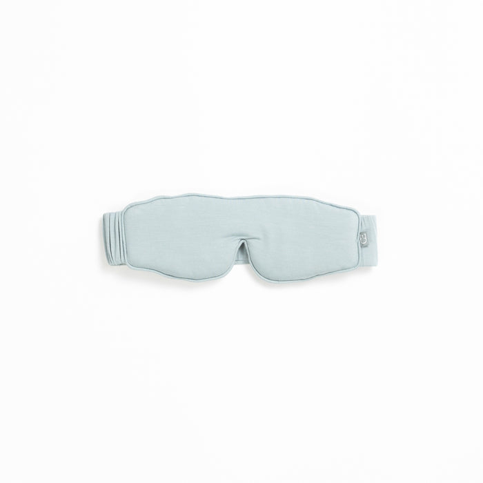 A light gray sleep mask from the Rest & Reset Bundle by Cozy Earth, featuring an adjustable strap, displayed on a white background.