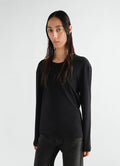 Rib long sleeve black jersey top by LEMAIRE worn by model front view with leather pants