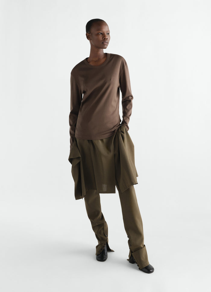 Rib long sleeve brown jersey top LEMAIRE worn by model with olive skirt and pants on white background