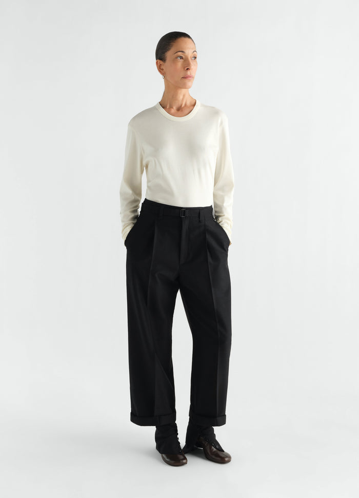 Rib long sleeve jersey top in off-white worn by a model with black trousers LEMAIRE front view