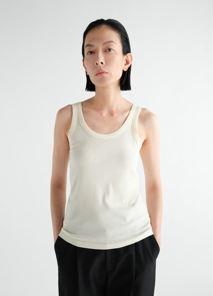 Rib jersey tank top in off-white worn by model front view LEMAIRE main look