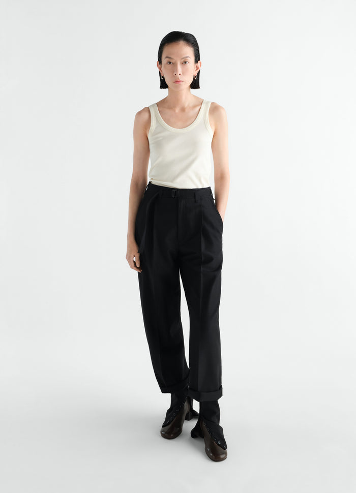 Rib cream jersey tank top LEMAIRE worn by model front view with black trousers on white background