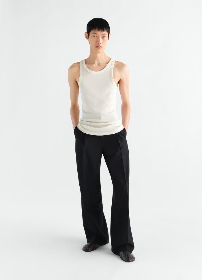 Tank top in cream ribbed jersey LEMAIRE worn by a model front view with black trousers