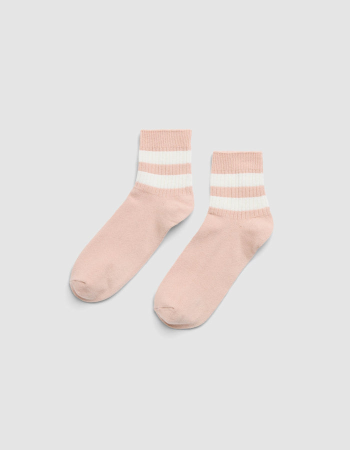 The Women's Sadie Sock by Cozy Earth features light pink fabric with two white and one beige horizontal stripes near the cuffs, shown on a light gray background.  |Color:Dusty Rose/Bone