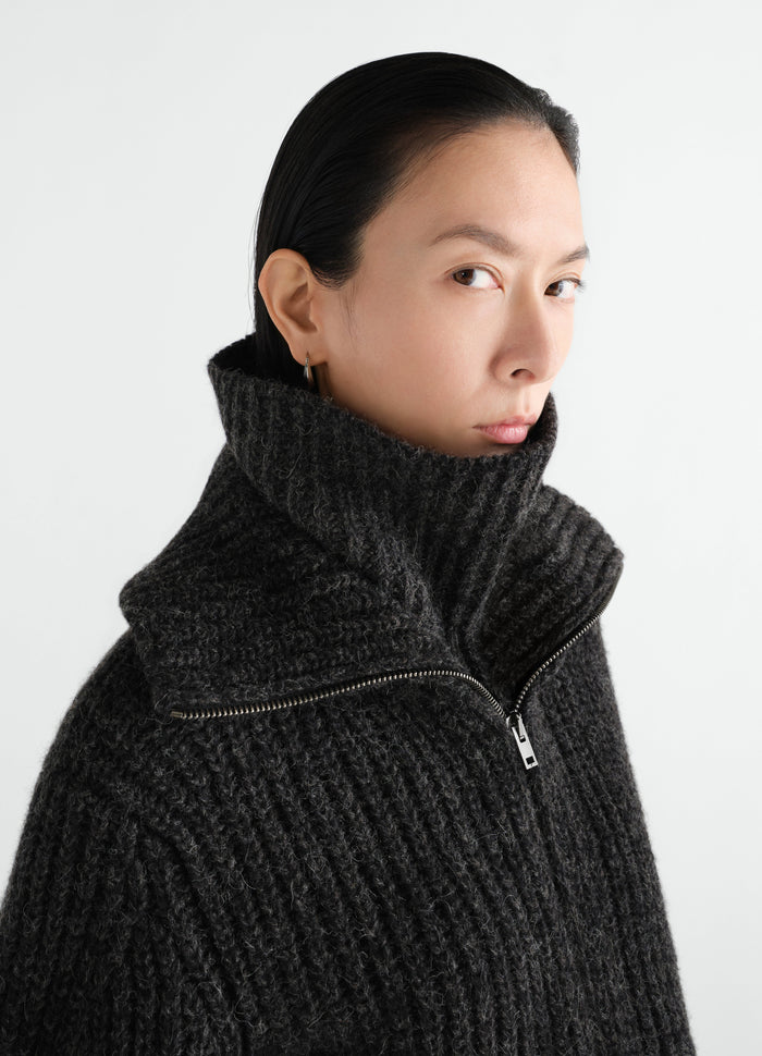 Neck warmer in dark grey alpaca and yak wool blend by LEMAIRE worn by model close-up front side view