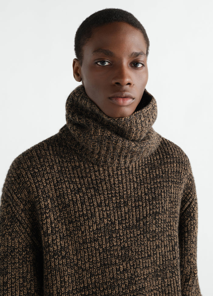 Neck warmer in brown alpaca and yak wool blend by LEMAIRE worn by a model, front close-up detail