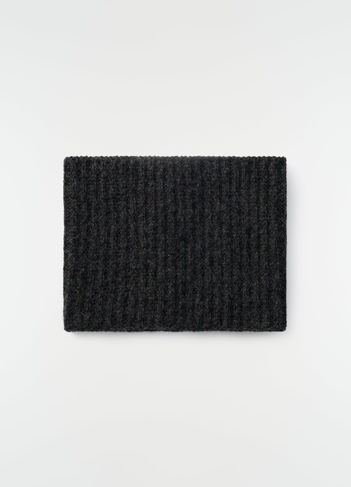 Neck warmer in black alpaca and yak wool blend by LEMAIRE flat lay on white background