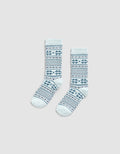 The Cozy Earth Snowflake Plush Lounge Sock features light blue fabric with dark blue geometric and snowflake stripes, shown on a plain light gray background.|Color:Mist