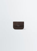 Soft brown leather card holder with silver clasp by LEMAIRE on plain white background front view.