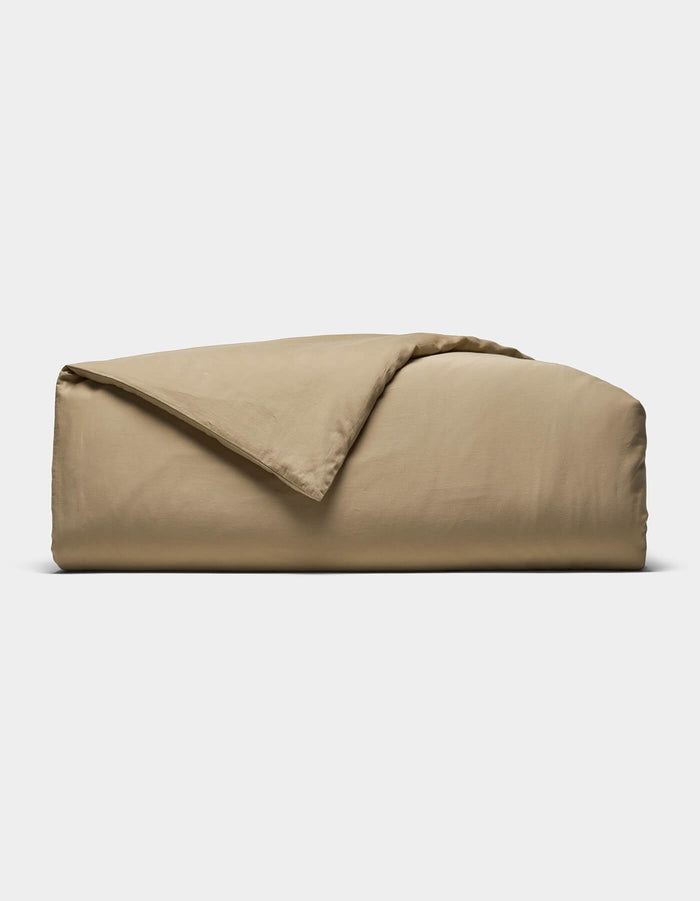 The Cozy Earth Soft-Wash Cotton Duvet Cover is shown folded with a corner turned back, set against a plain white background.|Color:Sandalwood