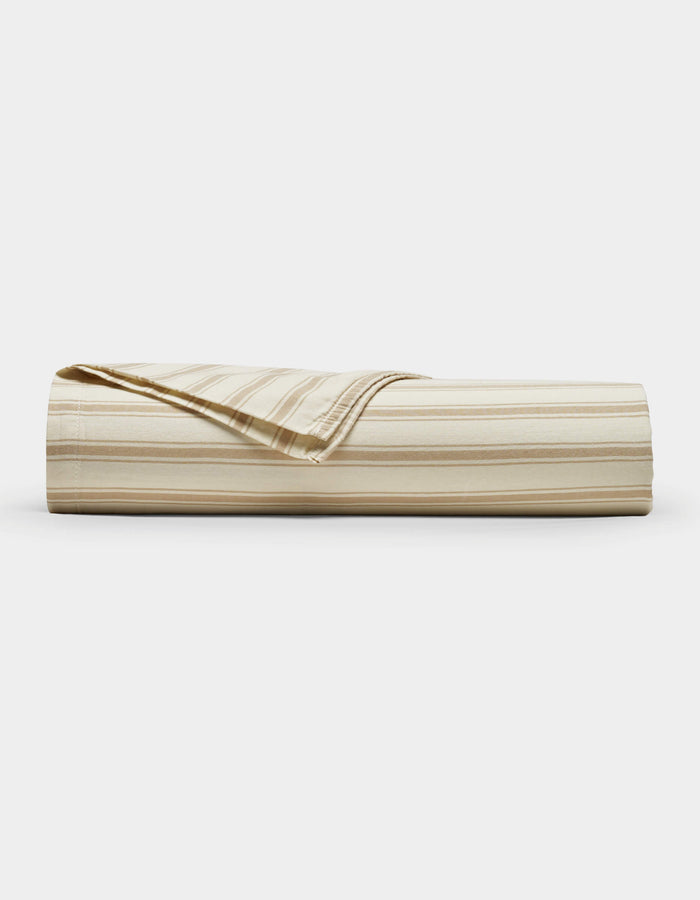 The Cozy Earth Soft-Wash Cotton Flat Sheet, shown neatly folded with a corner turned down to reveal the reverse side, features beige and cream stripes and is displayed against a plain white background.|Color:Coconut and Sandalwood Stripe