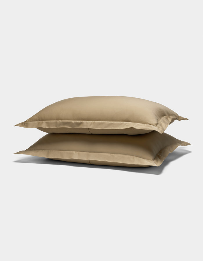 Two Cozy Earth Soft-Wash Cotton Shams in beige are stacked against a plain white background.|Color:Sandalwood
