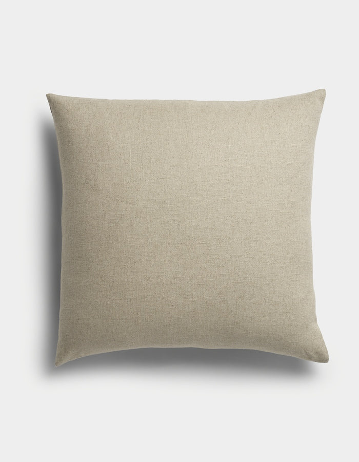 The Sonoma Throw Pillow by Cozy Earth is a square, beige cushion featuring a plain fabric texture, displayed against a white background with a soft shadow to the left.|Color:Tallow |Size:26" x 26"