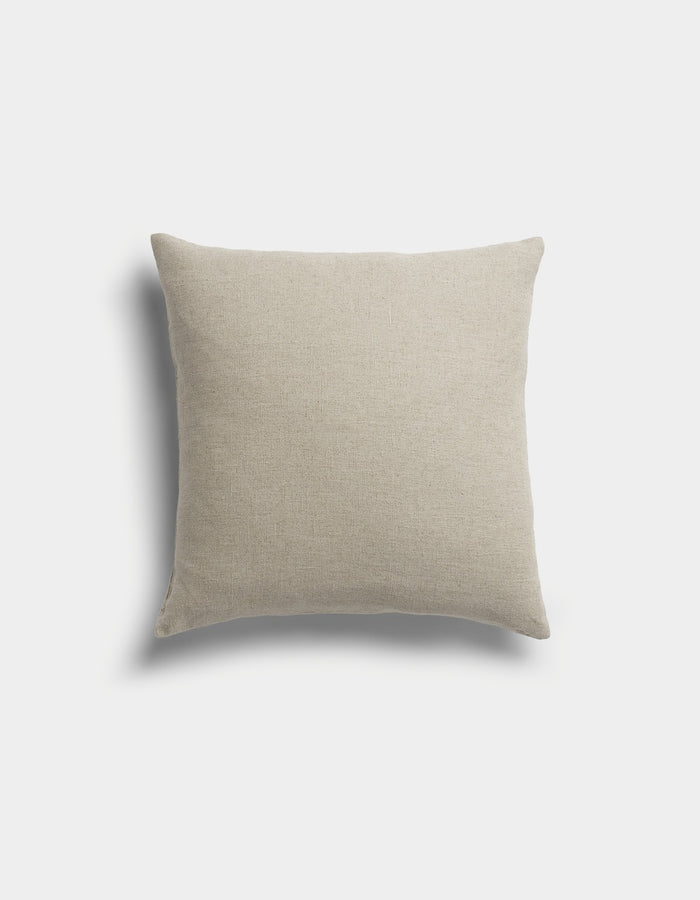 The Sonoma Throw Pillow by Cozy Earth is a square, beige pillow with a soft fabric texture, displayed against a light gray background with a faint shadow on the left side.|Color:Tallow|Size:20" x 20"