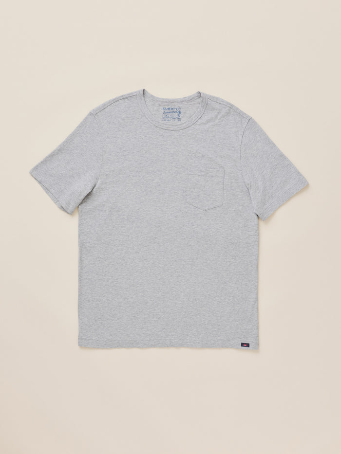 A light gray heather short-sleeve crewneck t-shirt with a left chest pocket, laid flat on a warm beige background.