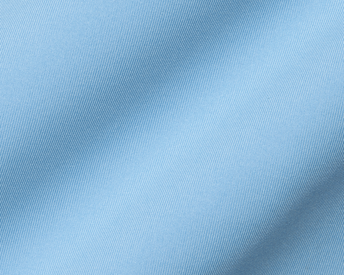 The Anderson Shirt: Vista Blue showcasing its light-blue woven fabric with diagonal ribbed texture, offering stretch, moisture wicking, and a soft drape.