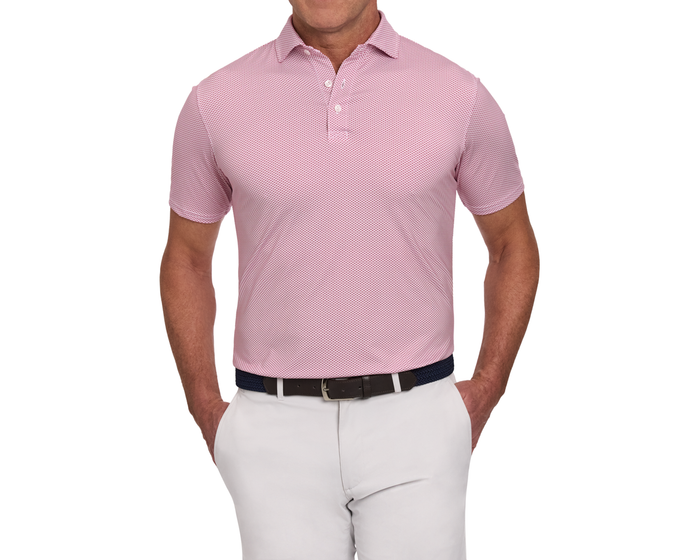 Man wearing The Armfield Shirt: Liberty Red, a textured, short-sleeve polo with a geometric pattern, tucked into trousers, featuring a structured collar and woven belt.