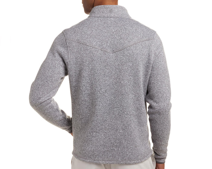 The Ashby Jacket: Heathered Gray, featuring a V-shaped yoke seam and turned-up collar, worn by a person with their hand on their hip.