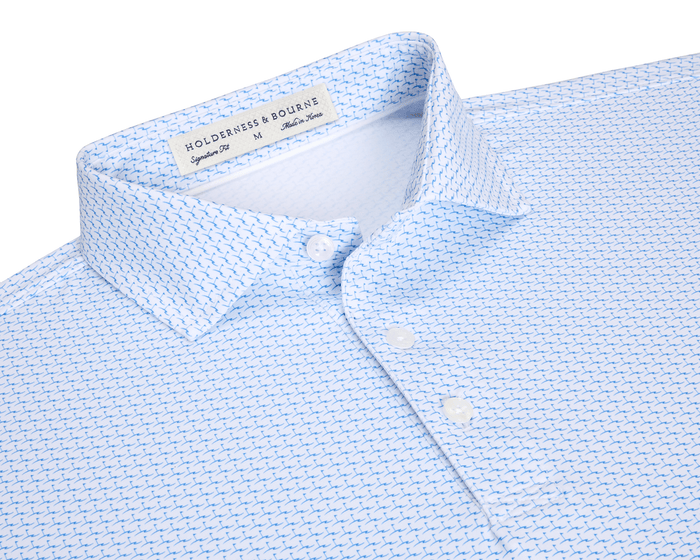 The Atwood Shirt: Horizon Blue features a light-blue button-down with a blue-plane motif, structured spread collar, and white buttons, ideal for versatile, active wear.
