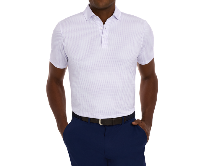 Man wearing The Atwood Shirt: Tudor, a short-sleeve polo with a subtle micro-pattern, paired with navy trousers and a black belt, hands in pockets.