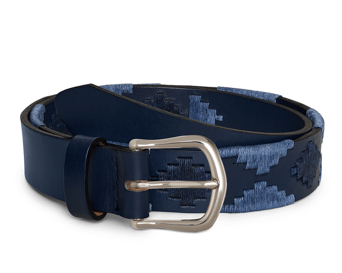 The Barker Belt: Navy & Slate features a coiled navy leather with a blue-threaded geometric pattern and a polished silver-tone buckle, showcasing Argentinean-inspired craftsmanship.