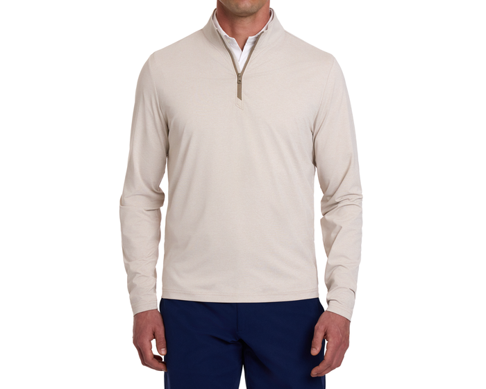 Man's torso in The Bell Quarter-Zip: Heathered Dune, showcasing a light beige pullover over a white shirt, paired with dark blue trousers.