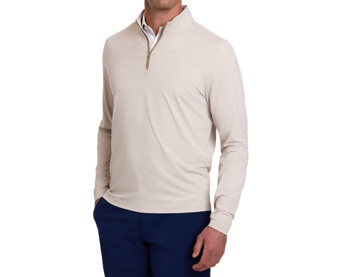 Man wearing The Bell Quarter-Zip: Heathered Dune over a white collared shirt with navy pants, showcasing its sporty, sophisticated design and comfortable fit.