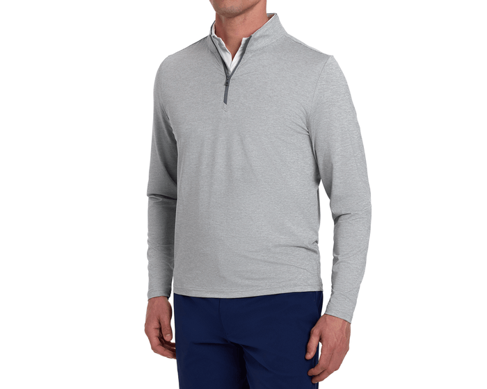 Man wearing The Bell Quarter-Zip: Heathered Gray, showcasing its modern styling over a white shirt with navy pants, highlighting its sporty, sophisticated look.