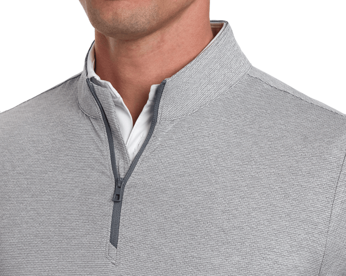 Man wearing The Bell Quarter-Zip: Heathered Gray, featuring a light gray texture, standing collar, and darker gray zipper accents over a white collared shirt.