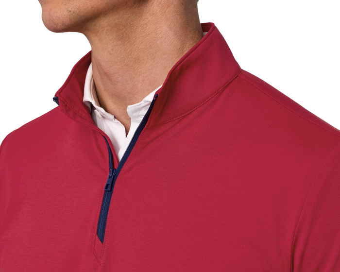 Close-up of The Bell Quarter-Zip: Heathered Liberty Red, showcasing its modern drop-tail silhouette layered over a white collared shirt, highlighting its sporty, sophisticated design.
