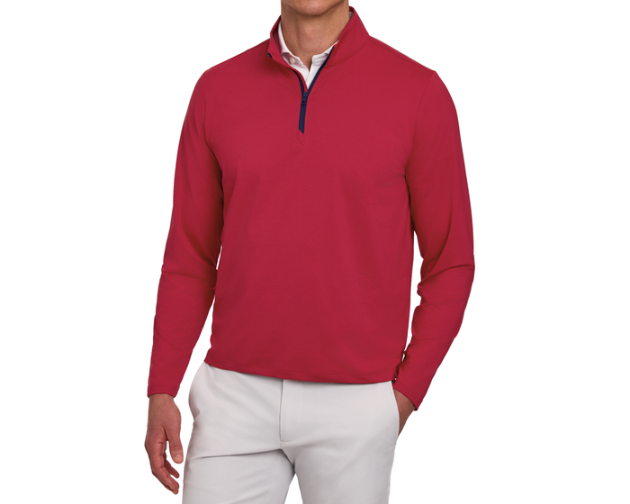 The Bell Quarter-Zip: Heathered Liberty Red on a mannequin, featuring a red pullover over a white shirt, paired with light trousers, showcasing sporty sophistication.