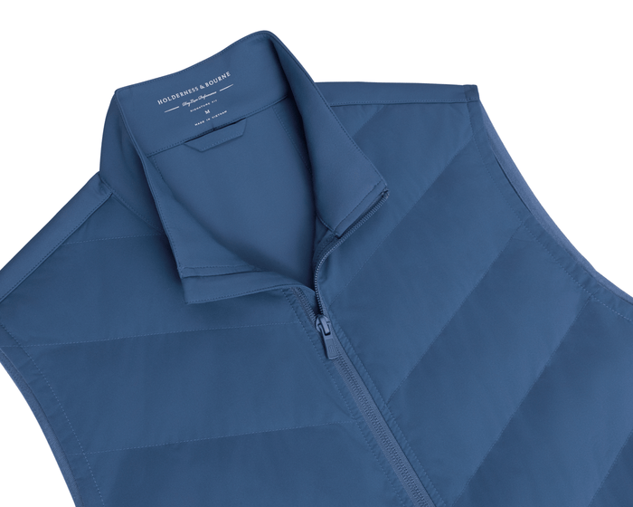 The Benton Vest: Andover, a men’s quilted sleeveless vest with a zip-front and stand-up collar, featuring Thermore® insulation and knit back for mobility.