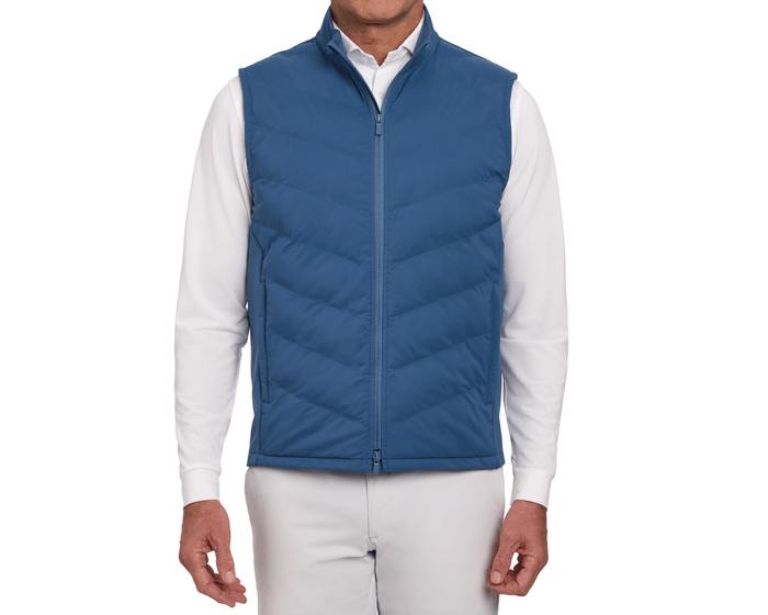 The Benton Vest: Andover, a quilted zip-front vest with Thermore® insulation and knit back, worn over a white shirt, emphasizing comfort and mobility.