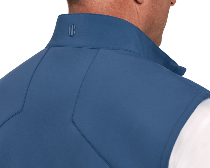 Rear view of The Benton Vest: Andover, showcasing its stitched panel seams, flipped collar with B logo, and knit back stretch construction for mobility.