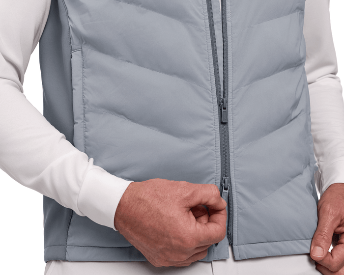 The Benton Vest: Gray, featuring a quilted front with a two-way zipper, shown zipped over a white long-sleeve shirt for comfort and mobility.